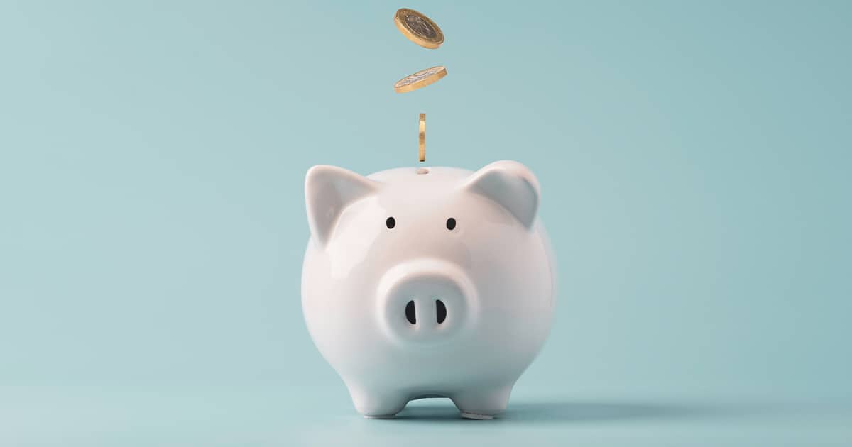 Coins falling to white piggy saving